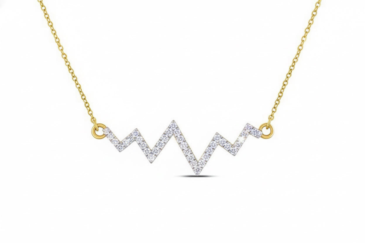Gold necklace with a zigzag diamond pendant on a white background