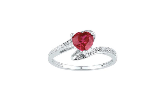 Heart-shaped lab ruby and diamond ring in sterling silver on white background
