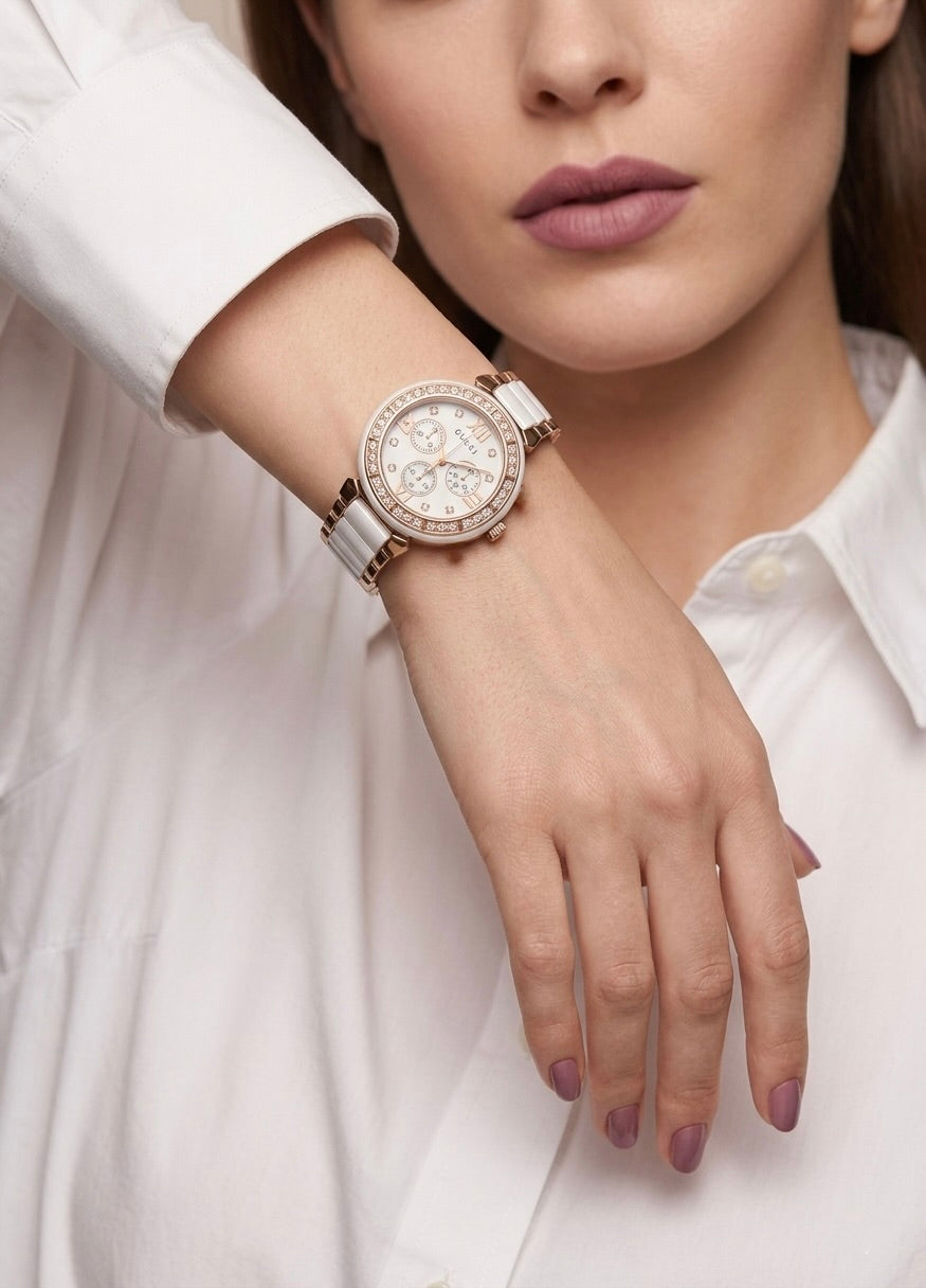 light pink women’s watch worn on wrist with minimalist outfit