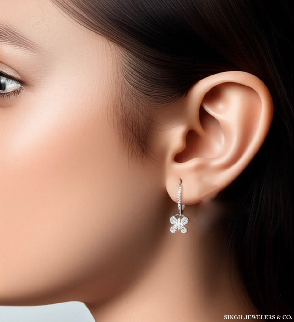 3.52 CT moissanite butterfly hoop earrings in sterling silver worn on model