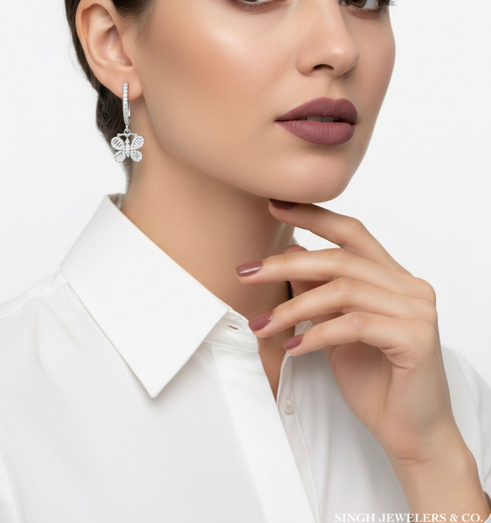 Butterfly hoop earrings with moissanite stones on model