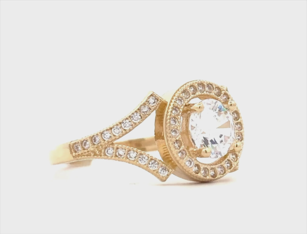14K yellow gold engagement ring featuring a round cubic zirconia center stone with a sparkling halo setting movie
