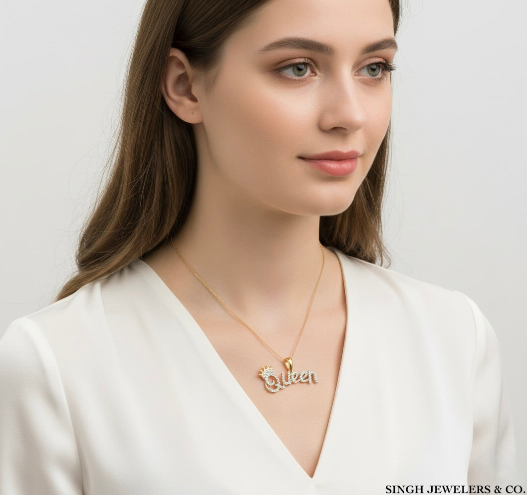 Woman wearing a gold necklace with a 'Queen' pendant on a plain background, branded 'Singh Jewelers & Co.'
