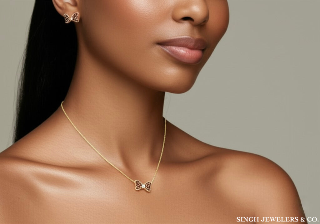 Woman wearing a gold necklace with a butterfly pendant, with 'Singh Jewelers & Co.' branding.