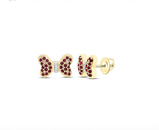 Gold butterfly-shaped earrings with red gemstones on a white background