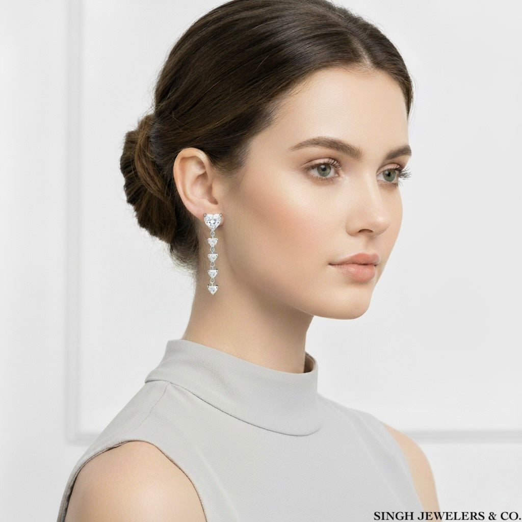 Woman wearing heart-shaped earrings with a plain background