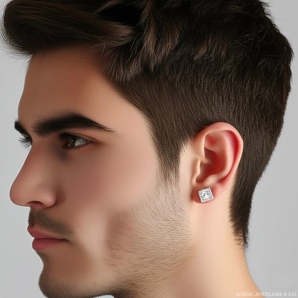 Close-up of a man wearing a diamond earring on a gray background