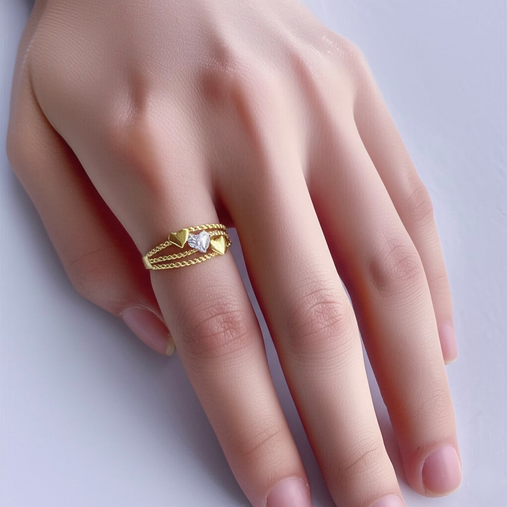 Gold ring with a diamond on a hand against a white background
