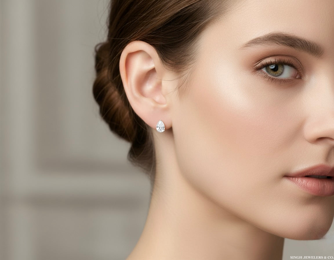 Close-up of a woman wearing diamond earrings with a blurred background
