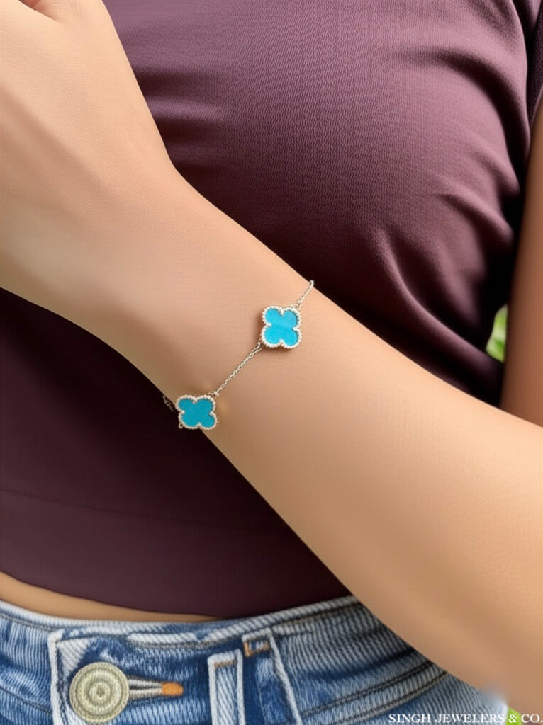 Stainless steel bracelet with sky blue clover design" or "Elegant stainless steel clover bracelet with sky blue color.