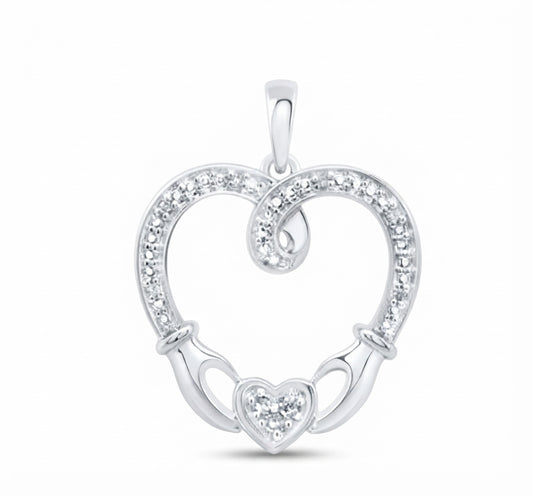 A sterling silver heart-shaped pendant with a Celtic claddagh design, featuring a heart in the center, two hands holding it, and a border of small clear stones, shown on a white background.