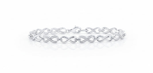 Silver bracelet with interlocking design on a white background
