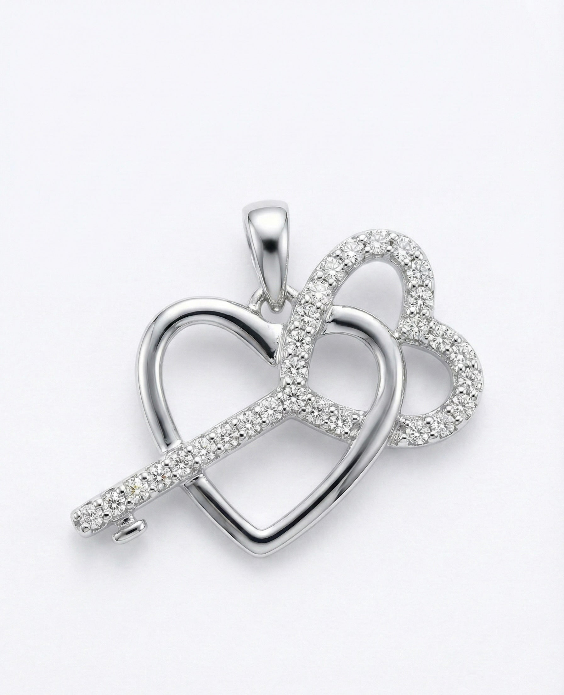 Silver heart-shaped pendant with embedded stones on a white background