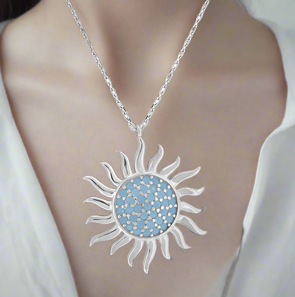 Sterling silver sun turquoise necklace with 18-inch chain.