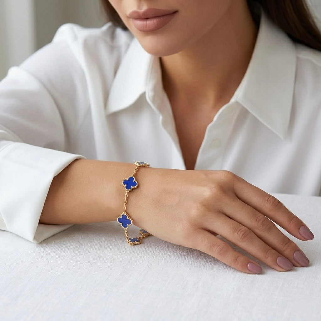Van Cleef inspired blue clover bracelet on woman’s hand