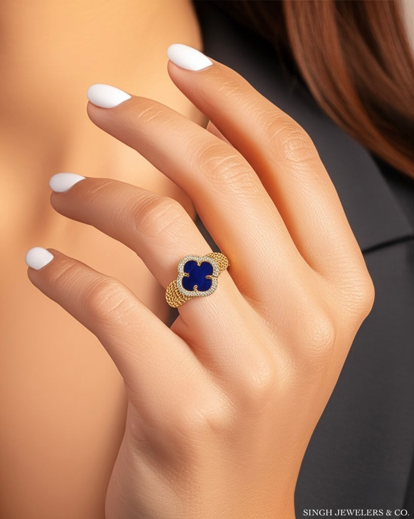 Woman wearing 14K yellow gold royal blue clover CZ ring