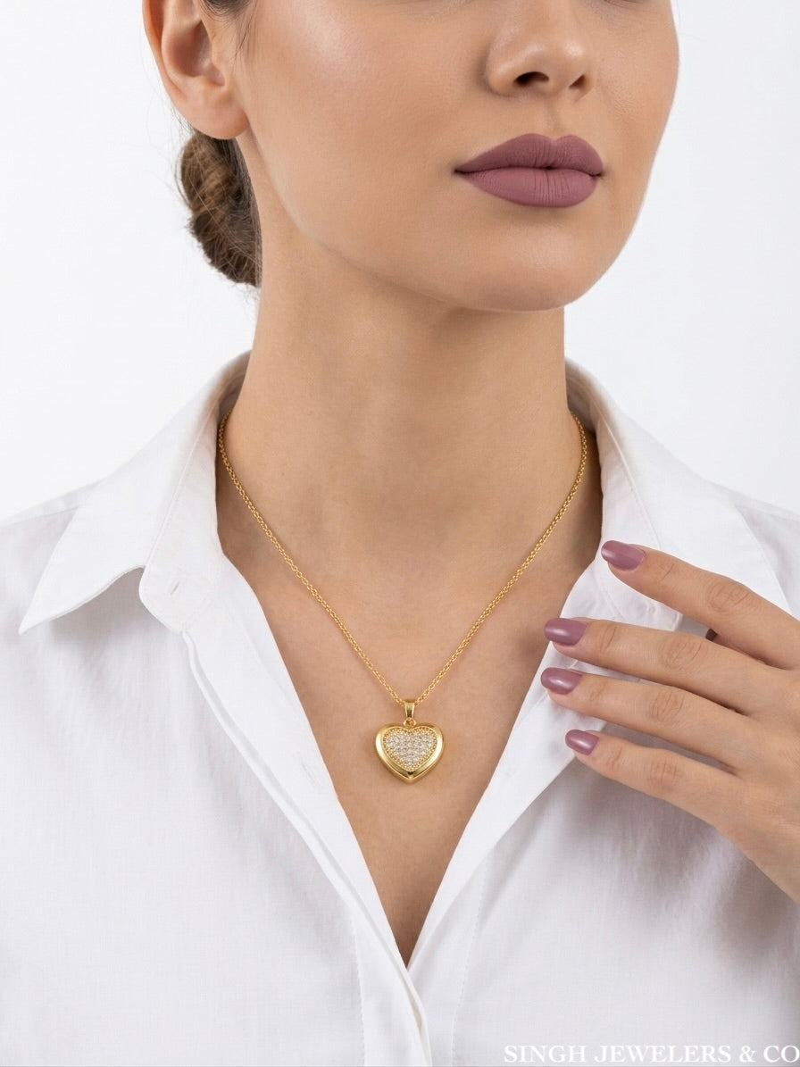 Woman wearing a stainless steel gold tone heart necklace with white sapphires, adjustable from 20 to 24 inches