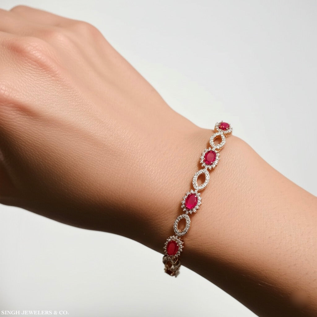Woman wearing 7-inch sterling silver bracelet with synthetic ruby and white sapphires