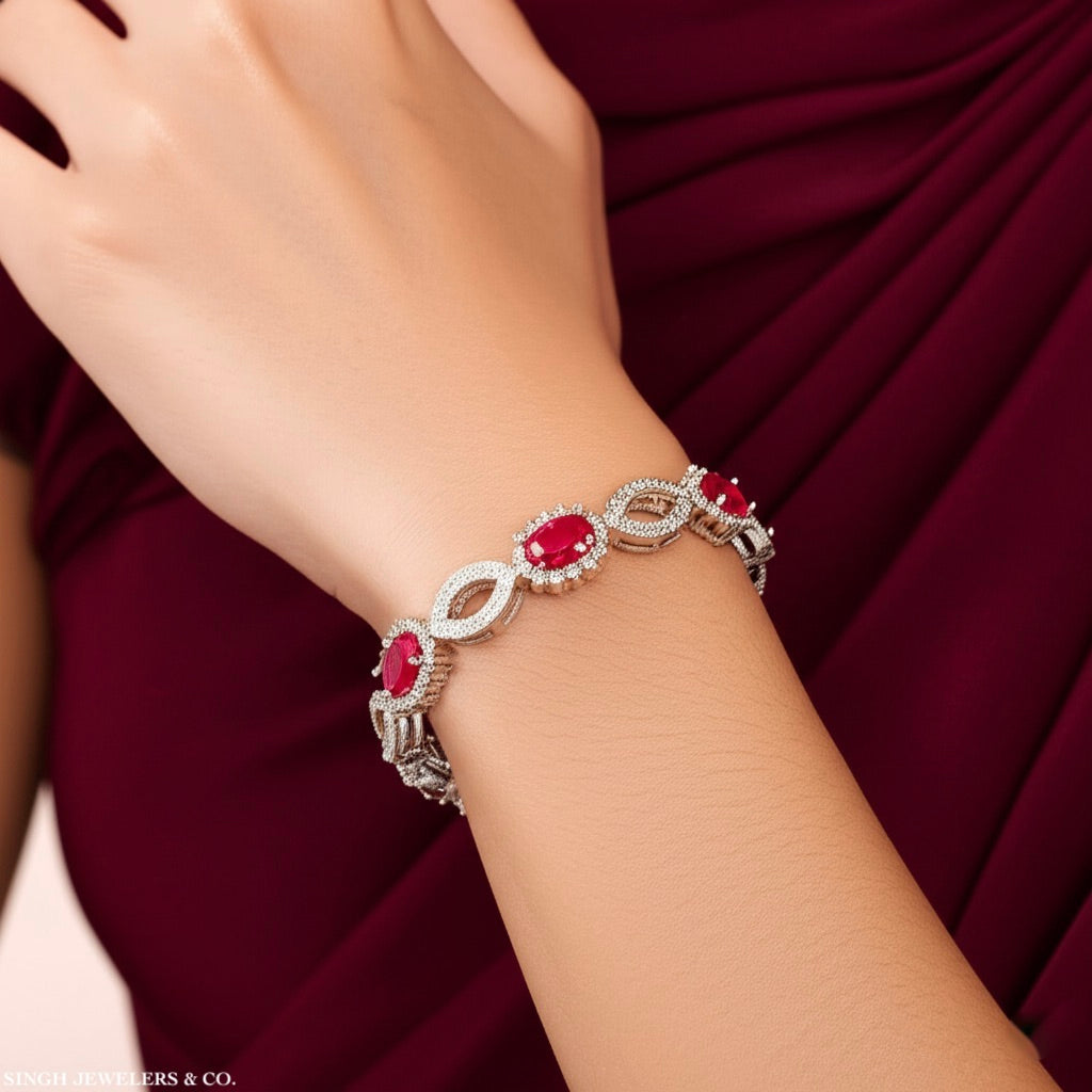 Woman wearing 7-inch sterling silver bracelet with synthetic ruby and white sapphires
