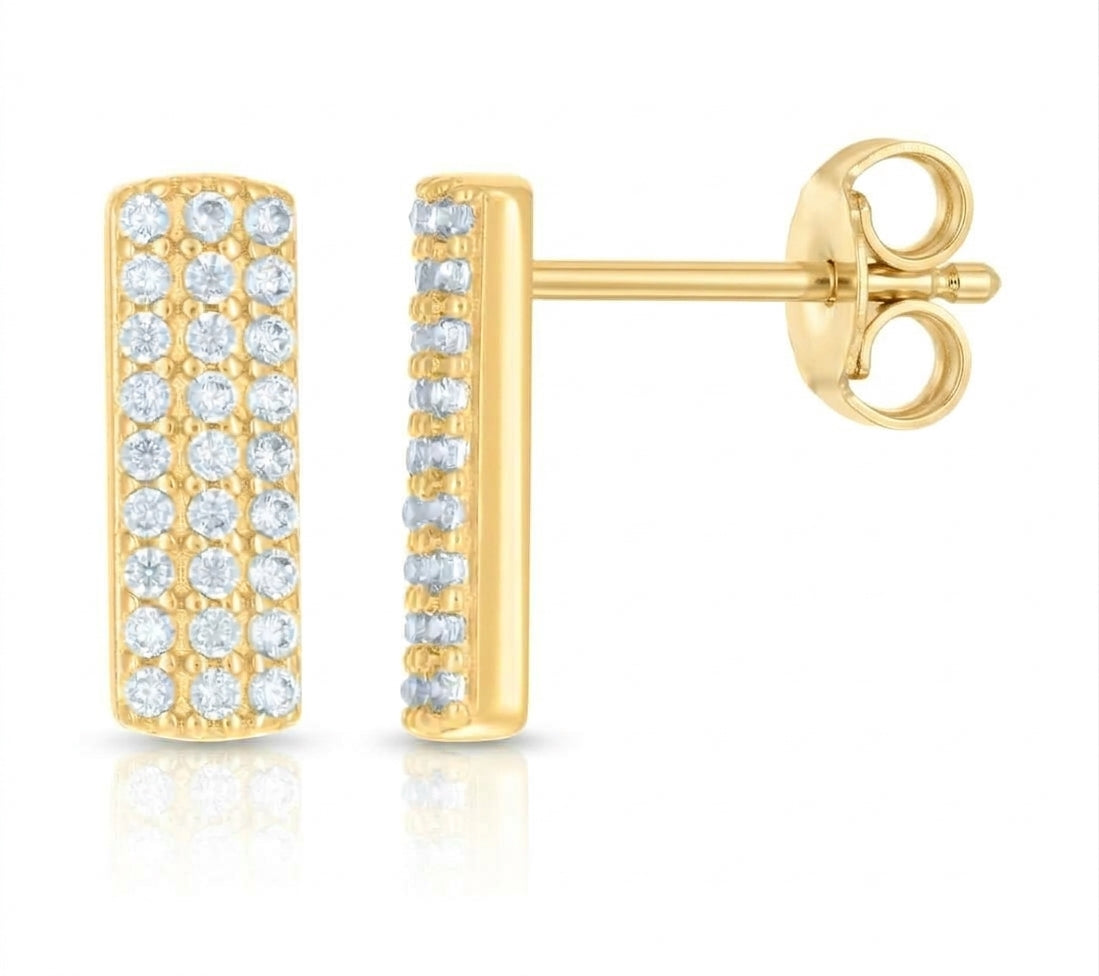 Close-up of cubic zirconia stones in elongated yellow gold bar stud earrings